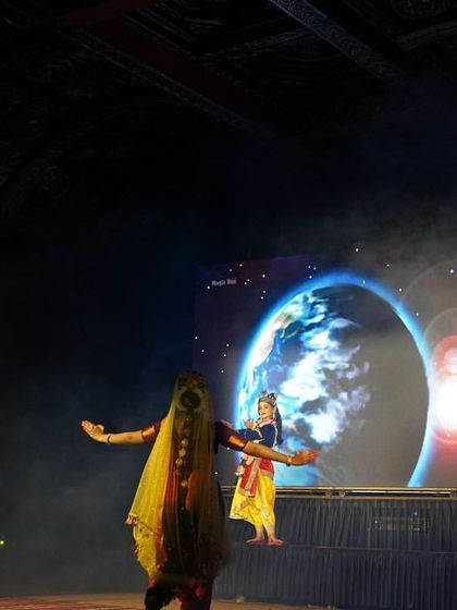 Another example of how we blend dance with digital art. A performer dances as the backdrop displays a stunning image of Earth from space, connecting the story to a universal scale.