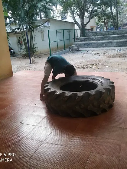 Another student takes on the tire challenge. We believe in hard, simple, and effective training.