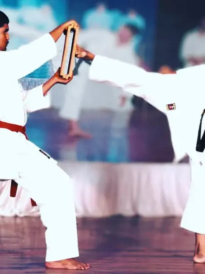 Consistency in practice leads to perfection. This young student demonstrates a flawless side kick break, a testament to his hard work and the quality of our fundamental karate instruction.
