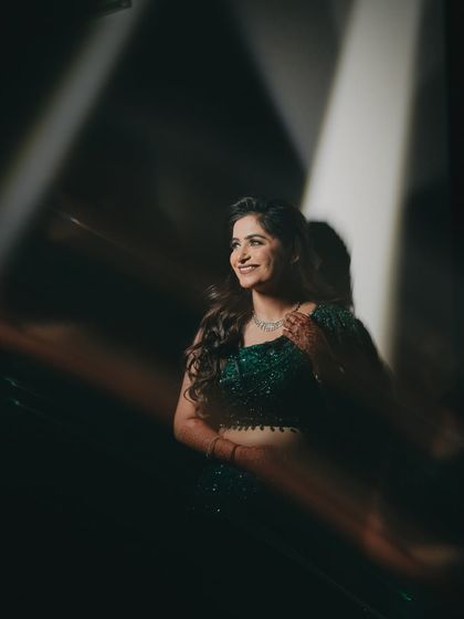 A candid, happy portrait of Shreya during an evening function. The lighting creates a dreamy, almost magical feel, capturing her joy in a natural and unposed way.