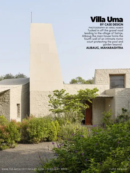 A view of Villa Uma, tucked off a gravel road in the village of Satirje. The home's unique form, with its prominent light tower, creates a distinctive silhouette against the lush Alibaug landscape.