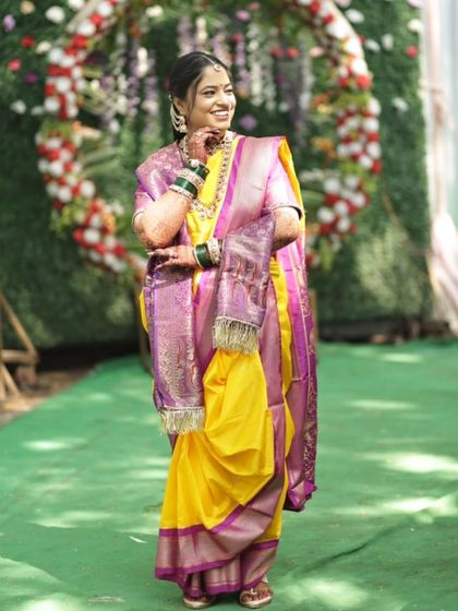 A candid, joyful moment. The bride's natural smile and the elegance of her traditional attire are the highlights of this photo.