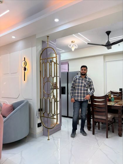 A view of the living and dining area, separated by a beautiful custom-made metal and glass partition that adds an artistic touch without closing off the space.