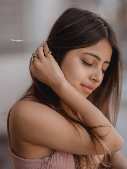 A gentle and thoughtful portrait. The soft focus and natural pose create a quiet, intimate mood.