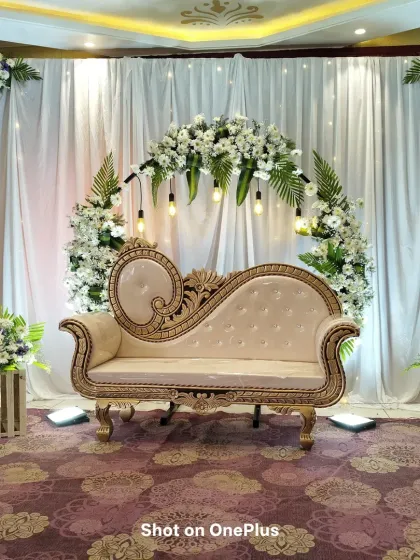 A straight-on shot of the white and green themed baby shower stage. The clean and fresh look is perfect for celebrating a new beginning.