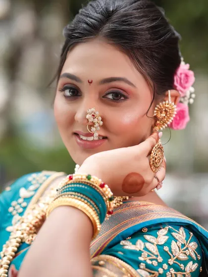 A close-up of the detailed eye makeup and the traditional 'nath' (nose ring). I teach my students how to apply makeup that enhances these beautiful features.