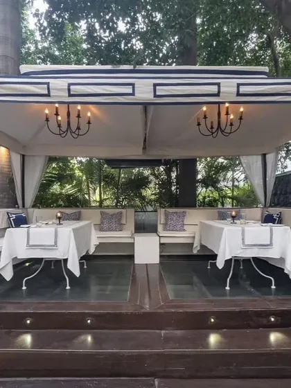 A daytime view of our outdoor seating, perfect for a weekend lunch. The white and blue theme is fresh and inviting under the sun.