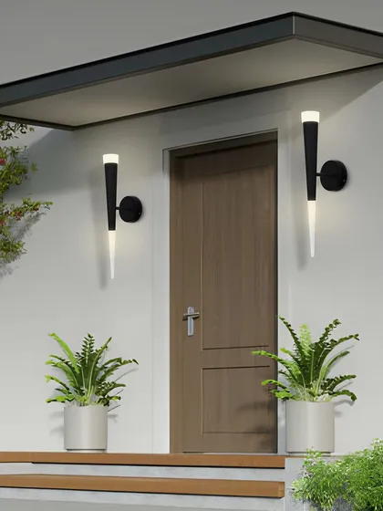 These torch-like wall sconces are suitable for both indoor and outdoor use. Here they are flanking an entryway, creating a welcoming and modern first impression.