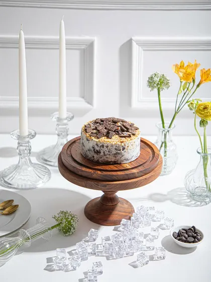 A wider shot of the Cookies and Cream ice cream cake, showing its place as the centrepiece of a beautiful dessert table.