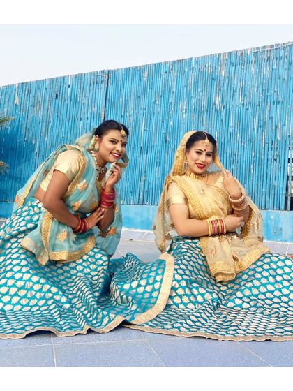 Two of our dancers in traditional attire, ready for a folk performance. We pay close attention to the details of costumes and presentation.