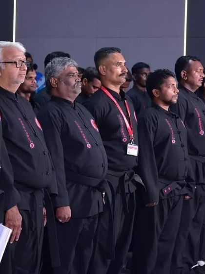 A line of our instructors and senior members at a formal event, standing with discipline and pride.