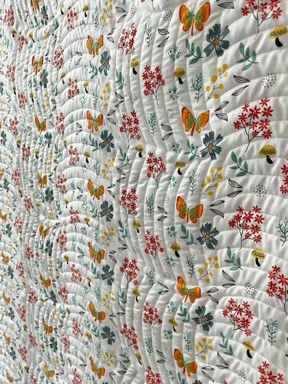 A close-up of the butterfly and floral backing fabric, showing the beautiful texture created by the quilting.