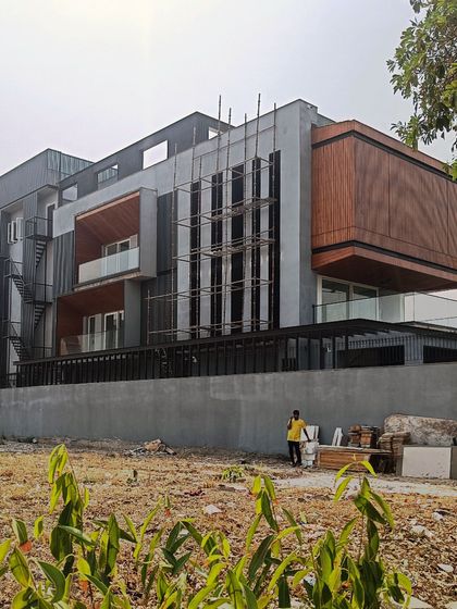 The Lakewood Residence under construction in Faridabad. This image shows the building's form taking shape, highlighting the interplay of different volumes and claddings.