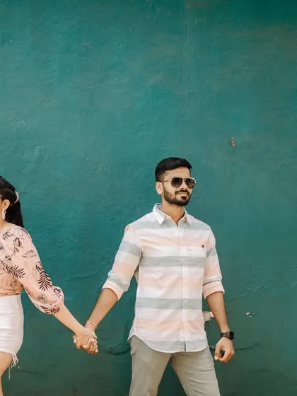 A cool, stylish portrait of Nikhil and Varsha against a vibrant wall in Goa. We love finding unique spots that reflect your personality.