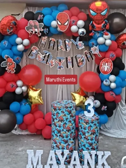 Another take on the popular Spiderman theme, this time with a white curtain backdrop. The balloon arch is accented with spiderweb details and character cutouts, creating a complete look.