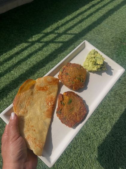 Holding a plate of my protein-rich breakfast. This meal, with its mushroom kababs and quinoa chilla, is designed to be satisfying and delicious, proving that diet food can be exciting.