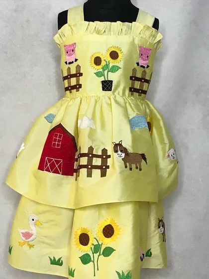 A dress that tells a story. This barnyard-themed dress, featuring embroidered farm animals and sunflowers, was so loved it was passed down from an older sister to the younger one.