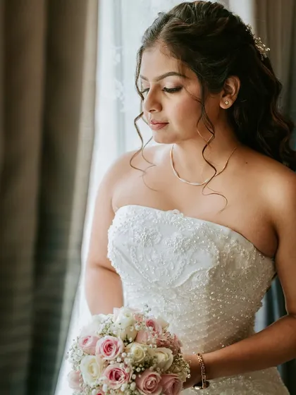Another beautiful close-up, showing the details of her dress, bouquet, and the soft, romantic makeup.
