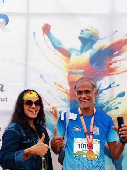 Posing with an enthusiastic runner after the event. I get my inspiration from the participants, and my goal is to make them feel like champions.