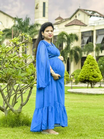 Taking the session outdoors adds a beautiful, natural element. Here, we used the soft light and lush greenery of a Bengaluru garden to frame this mother-to-be in a flowing blue gown, creating a serene and peaceful portrait.