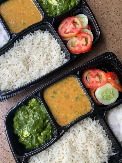 A close-up of my home-style meal plate, featuring Palak Paneer, Dal Tadka, rice, and salad. It's a nutritious and delicious option for your daily lunch.