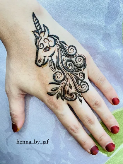 A fun and whimsical custom unicorn henna design on the back of the hand. This piece shows my ability to create unique, personalized art beyond traditional patterns.