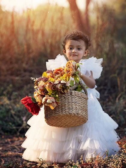 This little lady with her basket of flowers is just the sweetest thing. Outdoor photoshoots allow kids to be themselves and explore, resulting in beautiful, natural portraits filled with personality.