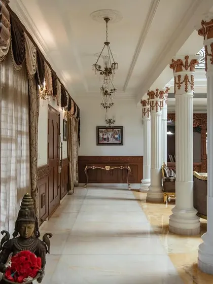 This shot of the corridor highlights the contrast between the dark, polished wood and the bright, reflective marble floor.
