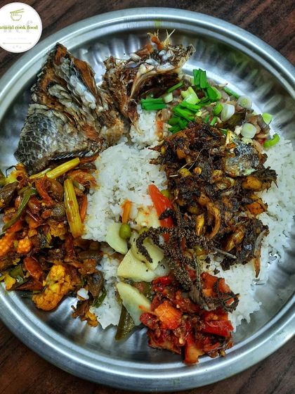 My personal plate with a little bit of everything: mixed vegetable fry, spicy chutney, fried tilapia, and a fish head stir fry.