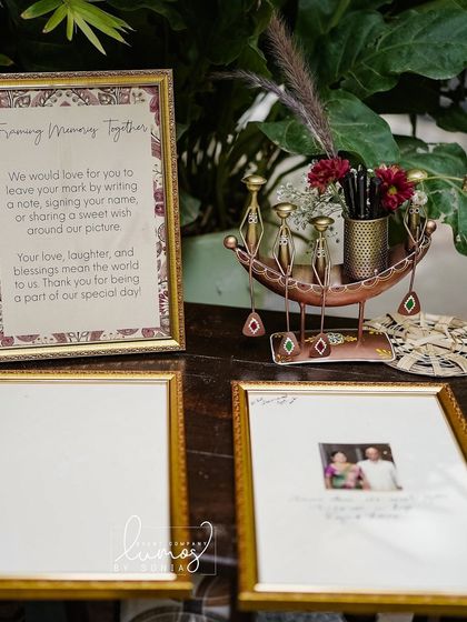 A detailed shot of the "Framing Memory Together" guest book station, a heartfelt way to capture memories.