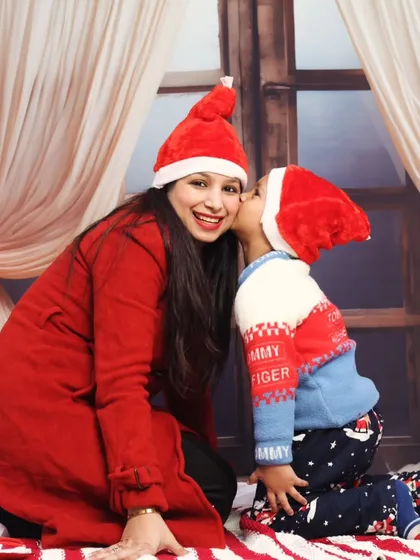 A sweet kiss on the cheek from a son to his mother during their holiday portrait session.