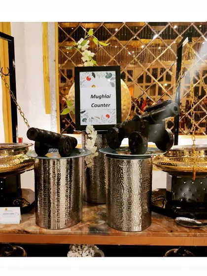 Our Mughlai Counter setup, elegantly decorated with miniature cannons, ready to serve a variety of royal delicacies.