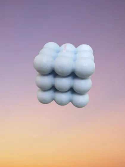 Another look at the bubble candle against a soft, gradient background. Its geometric shape and smooth texture make it a visually interesting item even when unlit.