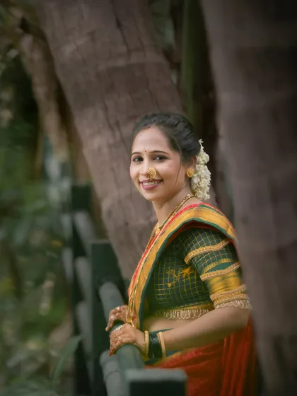 A lovely outdoor portrait of a woman in her festive attire. The natural setting complements the traditional beauty of the Vat Purnima celebration.
