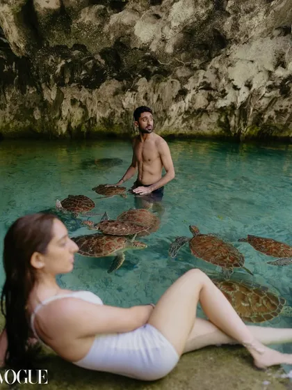 Another perspective from the Zanzibar turtle sanctuary. This shot has a candid, observational feel, as if we are peeking into a private, magical world shared by the couple and the surrounding nature.