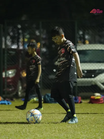A player focuses on their first touch, a fundamental skill we emphasize in our coaching.