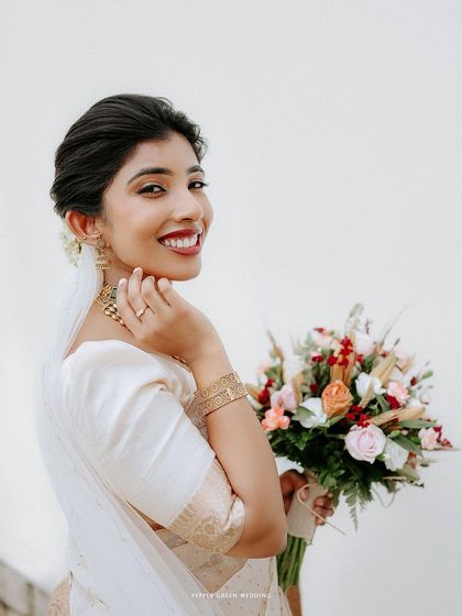 A beautiful portrait of the bride looking over her shoulder with a bright, happy smile.