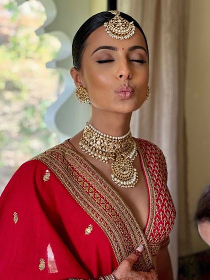 A cute and candid moment. I teach how to create makeup that allows the bride's personality to shine through.