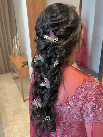 A closer view of the butterfly-adorned braid, showing the delicate details of the hair accessories.