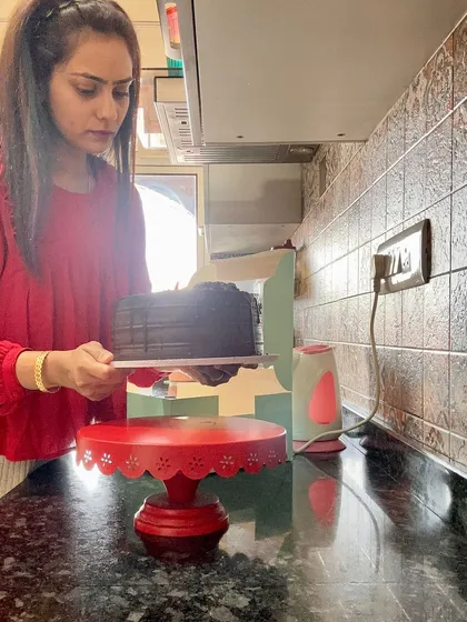 My obsession with making cakes never ends. Here I am in my kitchen, carefully transferring a rich chocolate cake, ready for its new home. I love everything about the process.