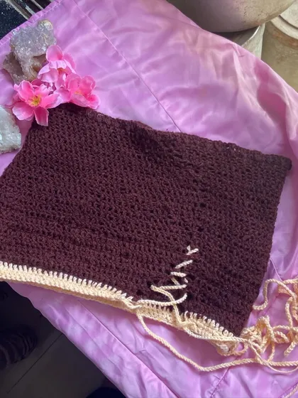 Another look at the brown crochet skirt, styled on a pink background to show the color contrast. Every skirt is made to order, so you can request any color combination you can think of.