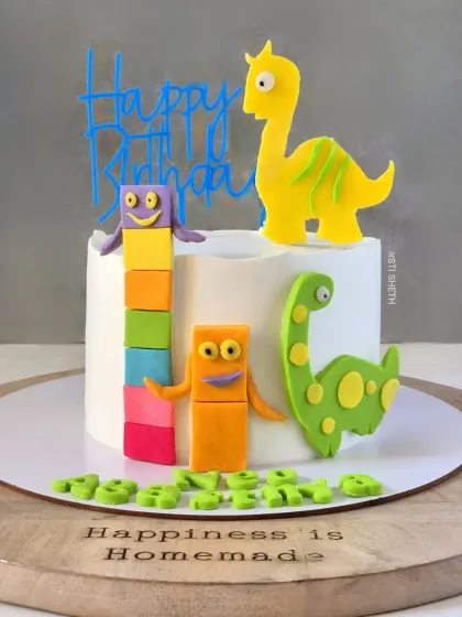 A playful and educational cake combining Numberblocks and dinosaurs. This Lemon Blueberry cake features colourful, handmade fondant toppers.
