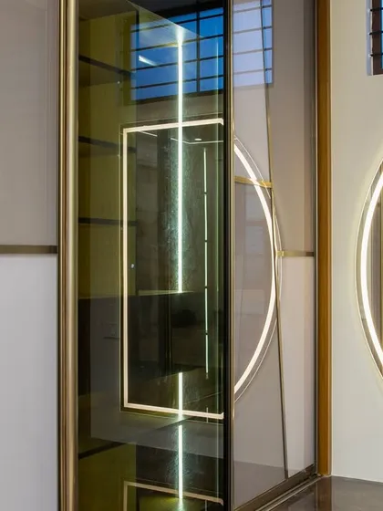 The details are what elevate a design from good to exceptional. For this wardrobe, I used a combination of tinted and frosted glass with geometric brass inlays and integrated lighting to create a piece that is as much a work of art as it is a functional closet.