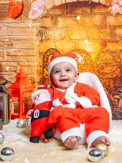 The cutest little Santa's helper you ever did see. I offer special holiday mini sessions, like this cozy Christmas fireplace setup, to capture the magic of the season.