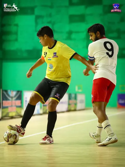 A player skillfully maneuvering the ball past an opponent in the semi-final.