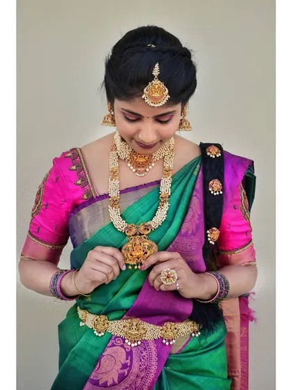 A candid moment of the client adjusting her jewelry. The makeup is designed to be long-lasting and look perfect from the first photo to the end of the event.