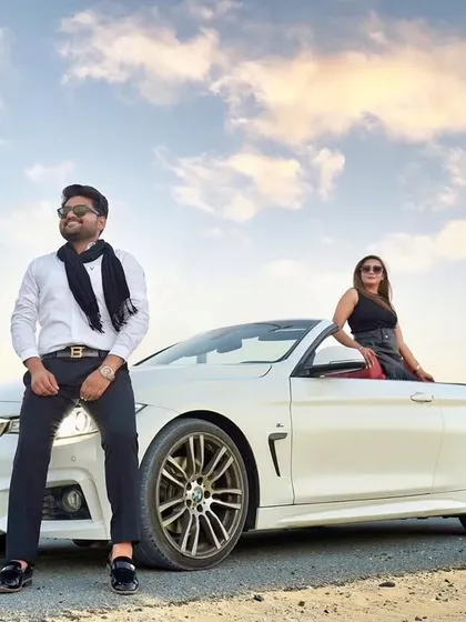 Cruising through Dubai with style. This shot with a white convertible BMW captures a cool, modern vibe against the city's impressive architecture and a beautiful sky.