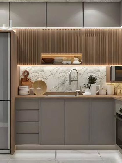 This compact kitchen design uses a combination of grey cabinets, wood-look paneling, and a marble backsplash. Integrated lighting and smart placement of appliances make this small space incredibly efficient.
