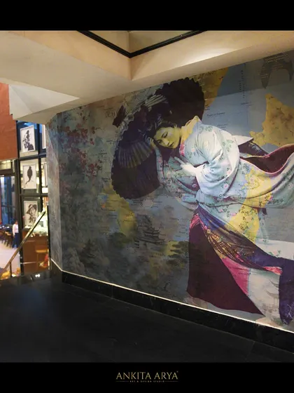 A bespoke mural for Shanghigh restaurant, featuring a geisha against a backdrop of a Southeast Asian map, installed along a staircase to create a dramatic visual journey.