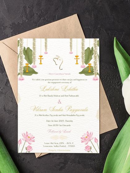 The full engagement invitation, beautifully blending minimalism with tradition. The design includes a subtle Ganesha motif for blessings, along with elegant lotuses and hanging lamps.